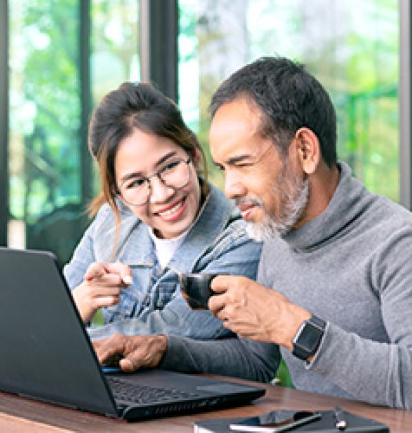 Man and woman looking at computer learning about technology
