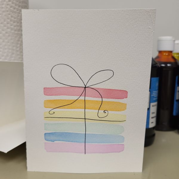 Rainbow striped present painted with watercolors.