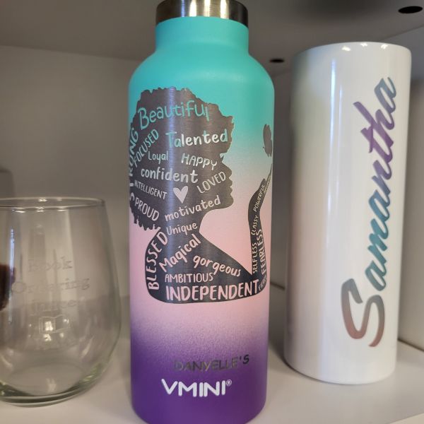 Blue-pink gradient powdercoated tumbler etched with a woman's silhouette and words of empowerment. 