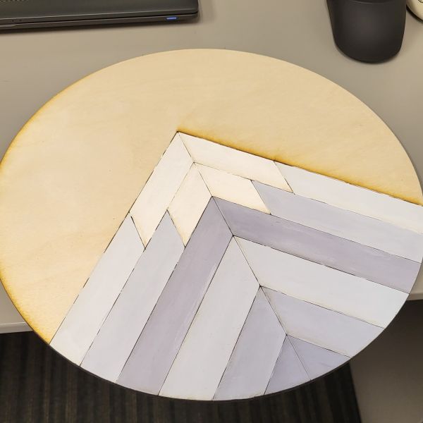 Geometric mountain painted with gradient purples on a round wood sign.