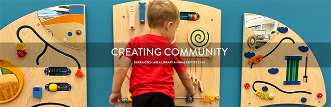 Young child wearing a red t-shirt is playing with the interactive elements inside the Library's new baby garden